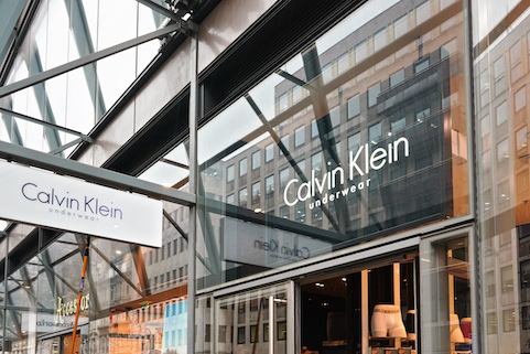 Calvin Klein Underwear retail store with sleek glass exterior reflecting modern urban architecture.