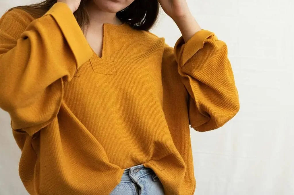 Durable knit sweater treated with Pilltec™ Anti-Pilling Fabric Technology for long-lasting wear
